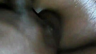 rubbing oil all over this ebony milf's big ass.