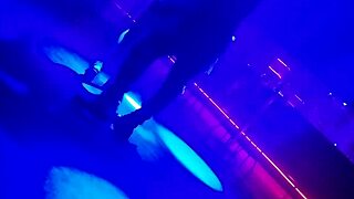 Go-go dancer invites brunette to dance and lifts dress