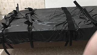 branquinho ties himself to the bed in a bdsm bondage session.