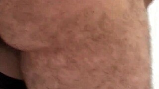 Hey, watch this horny milf suck two cocks and get drenched in hot cum!