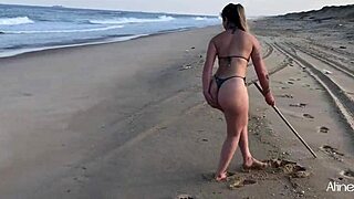 Blonde girl bends over for doggystyle sex with fan on beach.