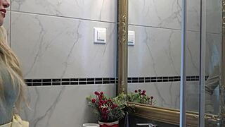 yo, check my sexy blonde wife changing panties in bathroom.