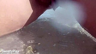 Chubby babe with shaved pussy caught peeing on public beach.
