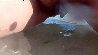 Chubby babe with shaved pussy caught peeing on public beach.