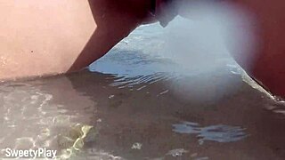 Chubby babe with shaved pussy caught peeing on public beach.