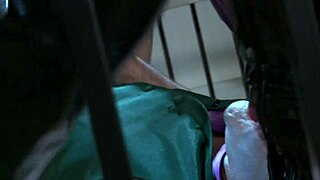 catwoman engages in a playful threesome inside the cage