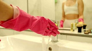 Cleaning lady milf stands in the bathroom with her legs spread