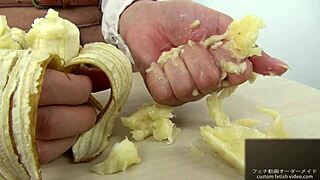 Asian girl dominates banana with hand crush fetish action. Pure intensity.