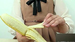 Asian girl dominates banana with hand crush fetish action. Pure intensity.