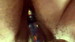 Curvy woman masturbates hairy pussy with glass dildo close up