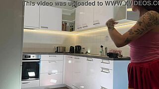 Redhead cheerleader shows see-through panties in kitchen