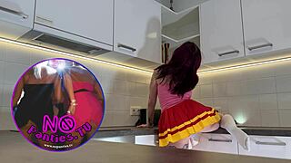 Redhead cheerleader shows see-through panties in kitchen