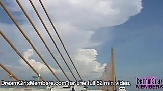 Brunette dream girl flashes big boobs topless in public convertible over skyway bridge