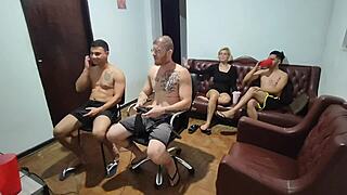 Friends playing video games turn to bareback anal sex.