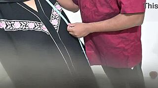 Tailor using hijab lady while taking measurement of blouse