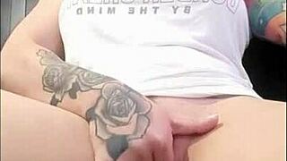 Redhead rubs her clit to orgasm watching porn