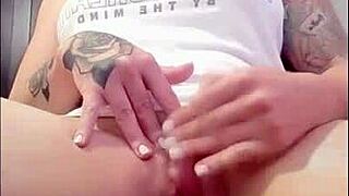 Redhead rubs her clit to orgasm watching porn