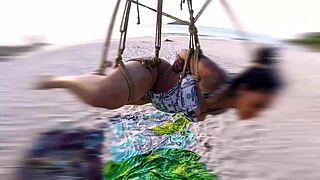 The shibarist ties the brunette in the coconut tree