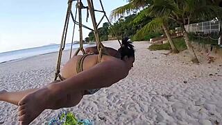 The shibarist ties the brunette in the coconut tree