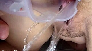 Watch this curvy slut in the public shower using a vaginal dilator while peeing!