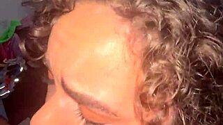 Curly-haired slut gets huge facial from handjob!