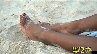 giggles' barefoot feet get all sandy at the beach