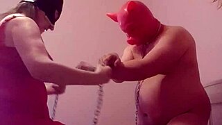 The slave is bound and dominated by the femdom mistress in intense bdsm session.