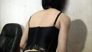 Masked shemale in lingerie crossdresses as a prostitute with voyeur watching.