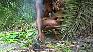 Passionate African Woman Cooks In Jungle