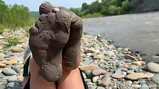 goddess shows you her messy nylon feet close ups in torn pantyhose on the river bank