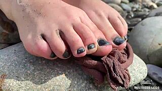 goddess shows you her messy nylon feet close ups in torn pantyhose on the river bank