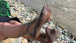 goddess shows you her messy nylon feet close ups in torn pantyhose on the river bank