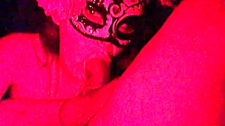 masked in red light sucking cock