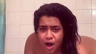 Fresh face contrasts with bare ass as she fucks herself in shower