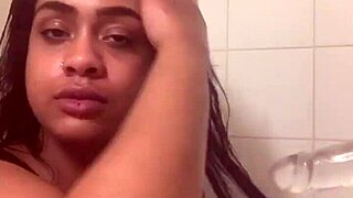 Fresh face contrasts with bare ass as she fucks herself in shower