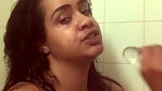 Fresh face contrasts with bare ass as she fucks herself in shower