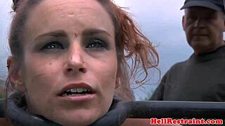 Bondage sub getting flogged outdoors by master with piercing and tattoos