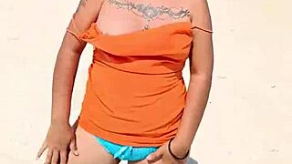 Hey, this horny Mexican babe flashes her thong and tits on the public beach! 😏🌊
