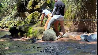 Amateur couple records outdoor adventure by the river