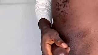 ninja man masturbates his big black cock and cums hard.