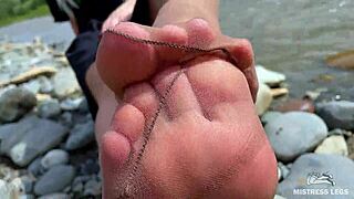 Goddess teases with nylon soles on riverside 😘