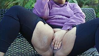 ebony woman relaxes intimately on outdoor public bench