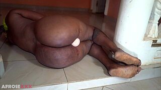 passionate ebony mom stuffs toy in plump folds