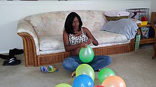 Black French woman meticulously inflates big balloons in detailed fetish sequence step by step
