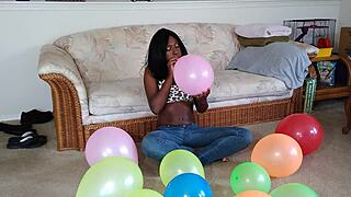 Black French woman meticulously inflates big balloons in detailed fetish sequence step by step
