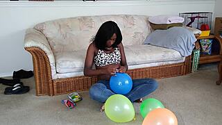 Black French woman meticulously inflates big balloons in detailed fetish sequence step by step