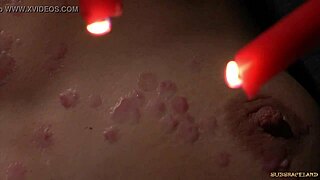 Redhead Endures Wax Play in Bondage for Intense Release