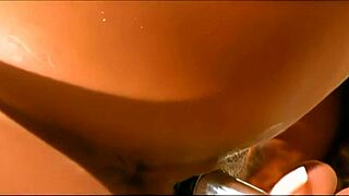 shaved pussy bitch masturbates wildly with toys on tropical beach