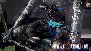 She submits to three layers of tight tape bondage in her shiny kigurumi mask and latex catsuit under femdom control