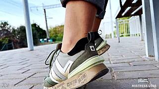 Tan nylon soles peek from blue jeans, teasing toes on the bench outdoors